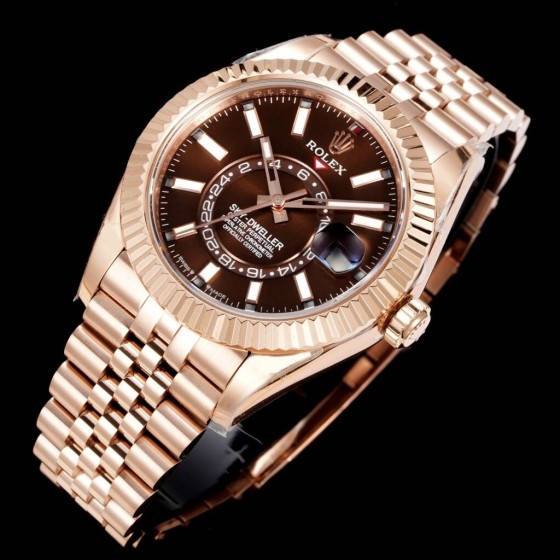 Navigator series men's watch with chocolate dial, rose gold bezel, 42mm case, and rose gold five-link bracelet.